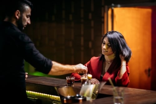 Illinois BASSET bartender serves drink to woman