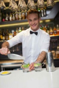 Happy bartender making a cocktail