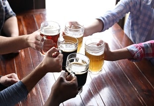 a group toasting with mugs of beer from Massachusetts