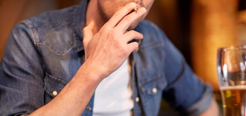 person smoking a cigarette for nicotine addiction