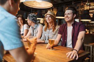 friends drinking beers at the bar on tables