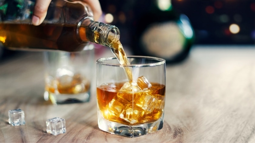 server pours a bourbon under the Alaska Dramshop laws