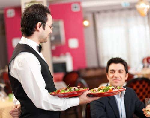 waiter serving food to customer