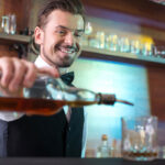 West Virginia bartender license course server making cocktail behind the bar