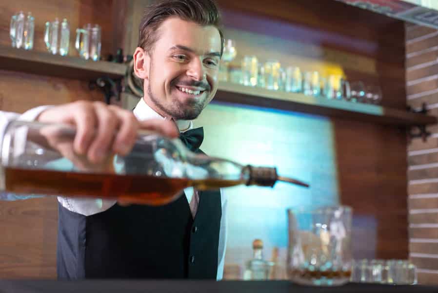 Bartender is making cocktail at bar counter