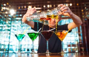 Barman show. Bartender pours alcoholic cocktails.