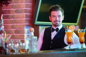 Bartender is making cocktail at bar counter