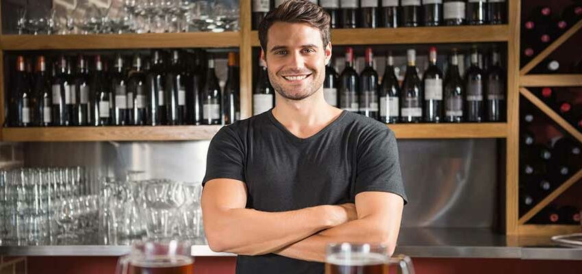 handsome bartender behind the bar, How Much Is a Bartending License?