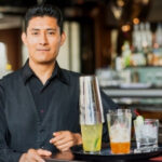 spanish Florida bartender with cocktail tray