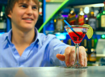 how old do you have to be to be a bartender, Young bartender makes cocktail in martini glass