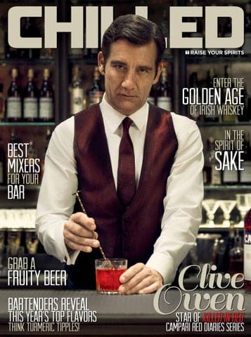 chilled magazine with male bartender using stirring spoon on red cocktail