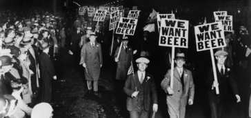 men walking with piquet signs protesting we want beer during prohibition