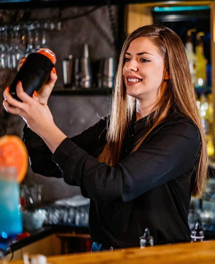 cheerful female bartender takes our Minnesota Alcohol Server Training Course for her Minnesota bartending license