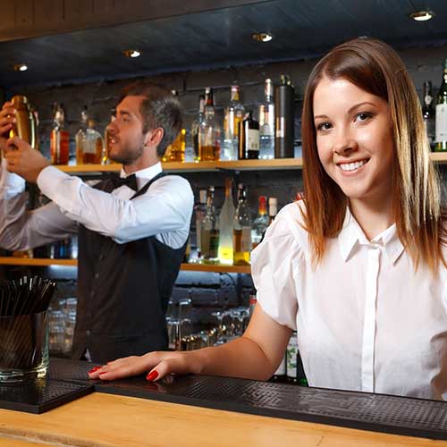 bartender and a waitress during work behind the counter