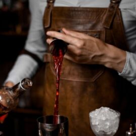 bartender-making-cocktails-pouring-alcohol-into-shaker