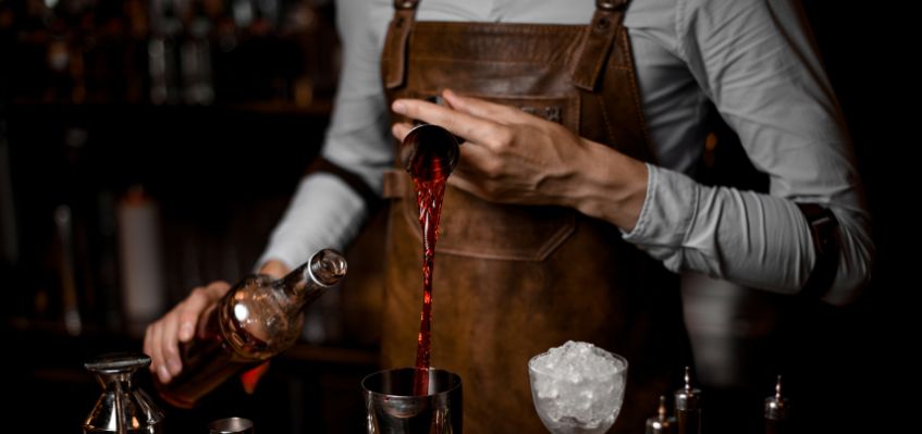 bartender-making-cocktails-pouring-alcohol-into-shaker