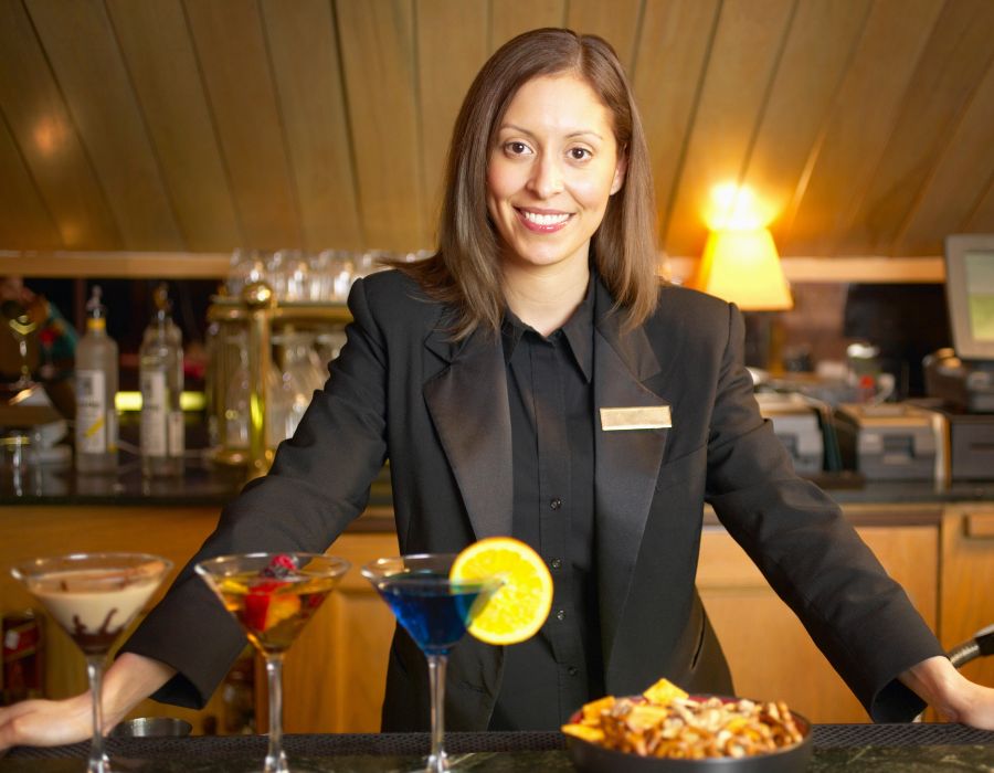 female bartender in suit behind counter at restaurant