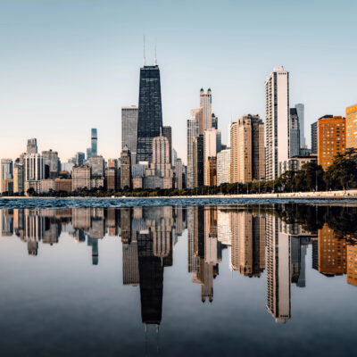 A high-contrast hero image featuring the Chicago skyline at twilight, with an official-looking overlay summarizing 2026 liquor codes and the new off-premise tax notice.