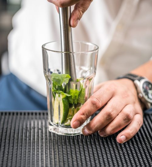 Bartender preparing mojito cocktail drink